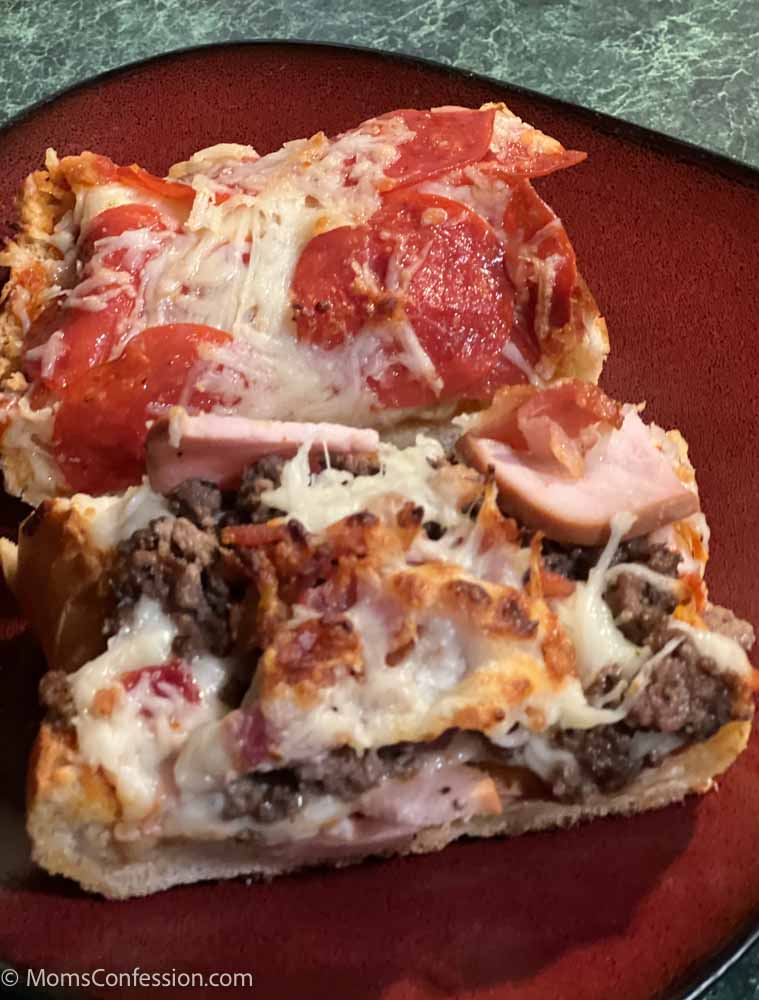 pepperoni french bread pizza and meat lovers french bread pizza on a red plate