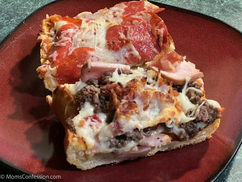pepperoni french bread pizza and meat lovers french bread pizza on a red plate