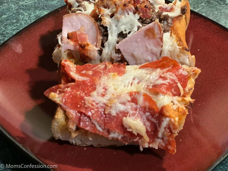 pepperoni french bread pizza and meat lovers french bread pizza on a red plate