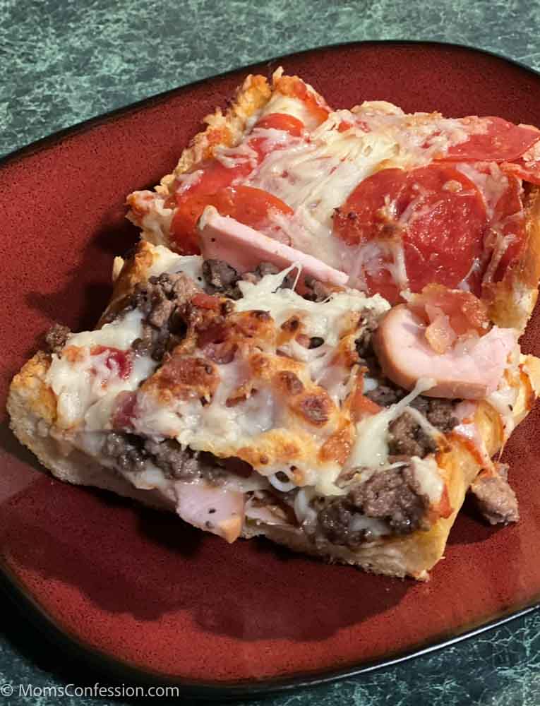 pepperoni french bread pizza and meat lovers french bread pizza on a red plate