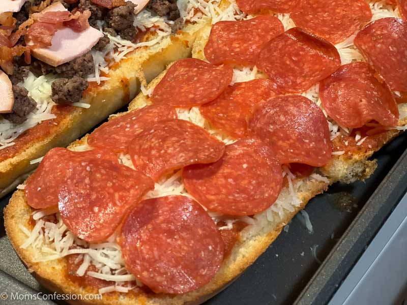 overhead photo of lpepperoni french bread pizza on a baking sheet