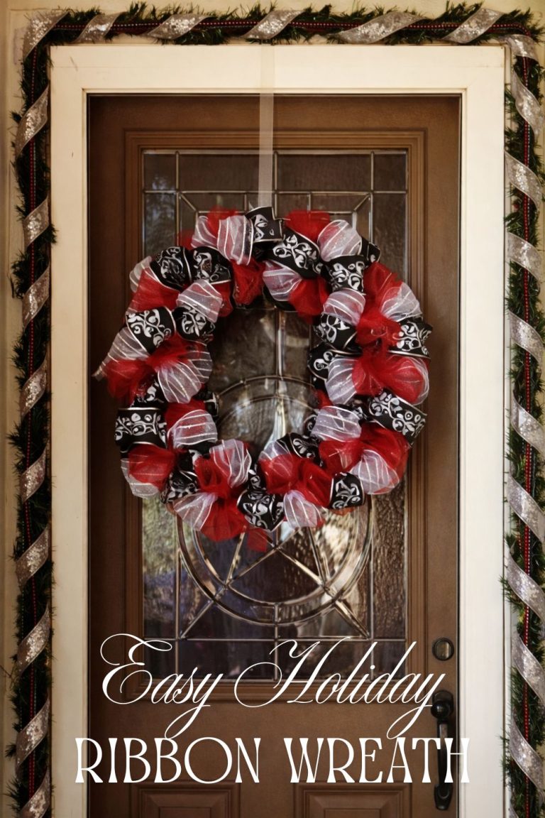 Red, black, and white holiday ribbon wreath hanging on a front door as festive DIY Christmas decor.