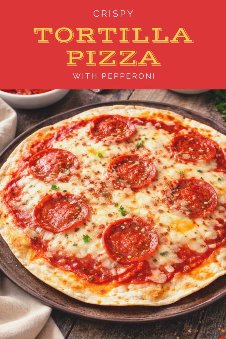 Crispy tortilla pizza topped with melted cheese, pepperoni, pizza sauce, herbs, and red pepper flakes on a round baking pan.