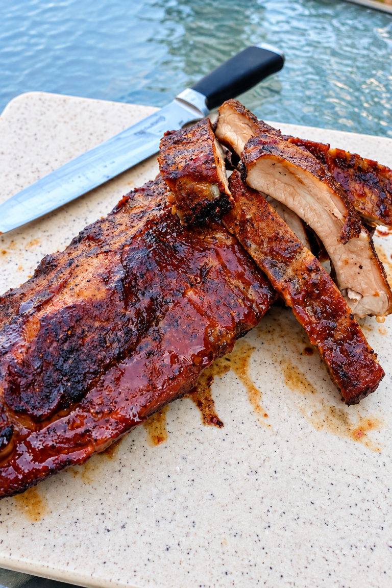 Tender smoked ribs with a caramelized barbecue glaze sliced and ready to serve