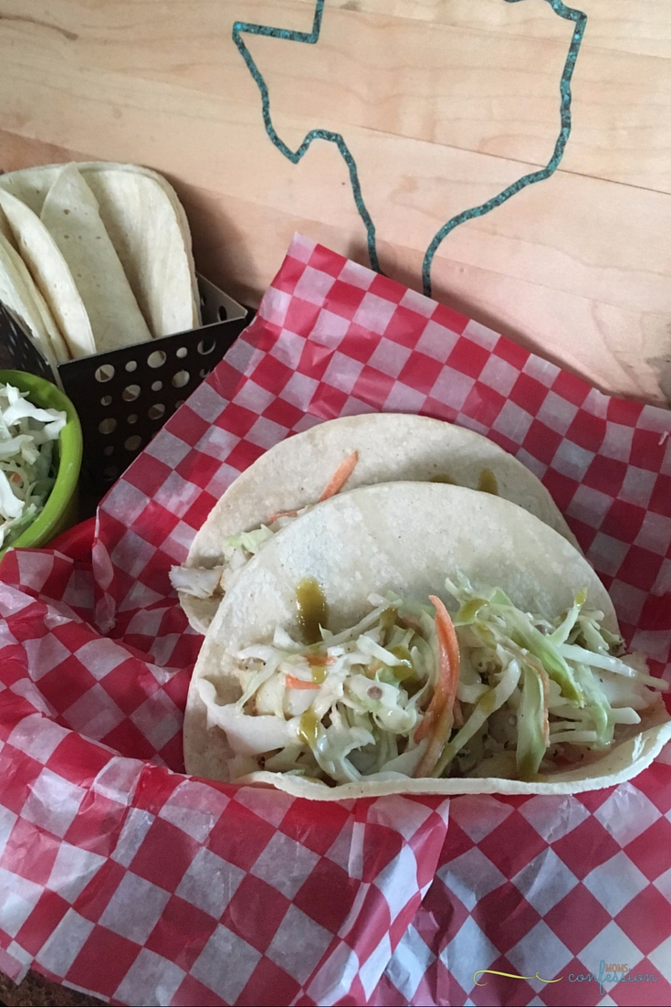 Delicious and easy Tex-Mex Fish Tacos - a hint of sweet and spicy Texas flavor packed into a corn tortilla with coleslaw and serrano sauce.