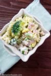 Vertical photo overhead of Leftover Ham Pasta Recipe in a white square bowl on a table ready to eat