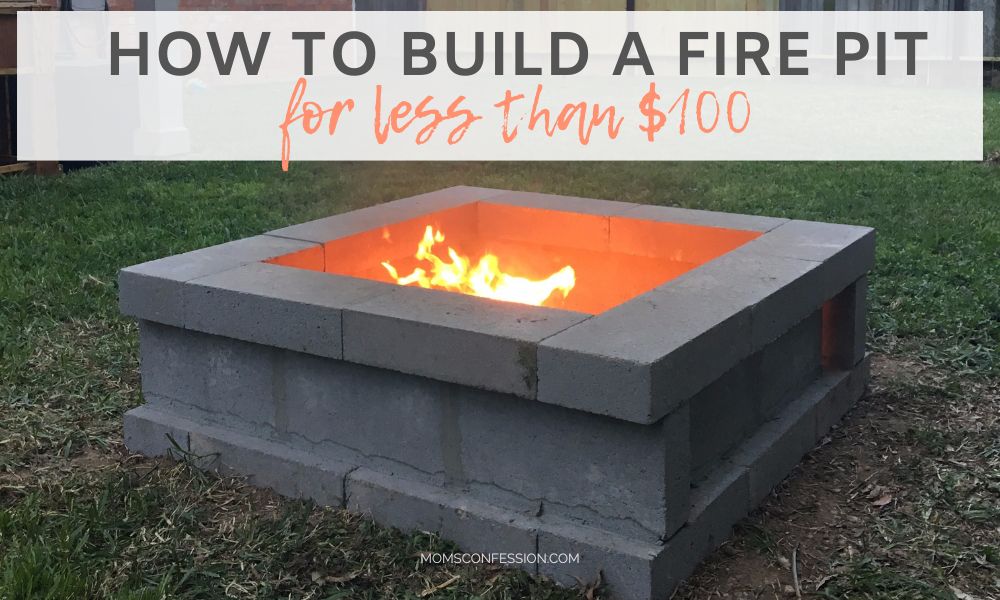 backyard fire pit made from stacked concrete blocks with flames showing in the center